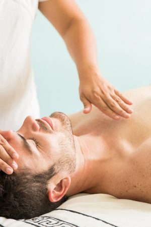 bigstock-Reiki-Therapy-On-A-Young-Man-212992810