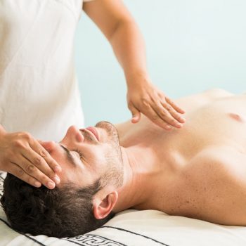 bigstock-Reiki-Therapy-On-A-Young-Man-212992810